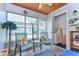 Enclosed lanai with tile floors, seating, and access to laundry area with washer and dryer at 13870 Oakwood Ln # 13870, Seminole, FL 33776
