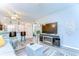 Bright living room with modern furniture and decor, open to the kitchen at 13870 Oakwood Ln # 13870, Seminole, FL 33776