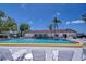 Beautiful community pool area with ample seating and clear blue water at 13870 Oakwood Ln # 13870, Seminole, FL 33776