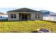Backyard view showcases a well-maintained lawn and patio with a built-in fire pit at 1430 Blue Horizon Cir, Bradenton, FL 34208