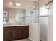 Modern bathroom featuring a double sink vanity with dark wood cabinets and a glass enclosed shower at 1430 Blue Horizon Cir, Bradenton, FL 34208