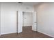 Bright bedroom with wood-look flooring, white trim, and an open doorway to another room at 1430 Blue Horizon Cir, Bradenton, FL 34208