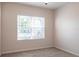 Cozy bedroom featuring carpet, a large window with blinds, and neutral wall color at 1430 Blue Horizon Cir, Bradenton, FL 34208
