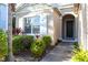 Close up of the front entryway featuring well-manicured landscaping, large windows, and white shutters at 1430 Blue Horizon Cir, Bradenton, FL 34208
