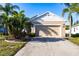Charming single-story home with a two-car garage and tropical landscaping at 1430 Blue Horizon Cir, Bradenton, FL 34208