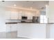 Modern kitchen with white cabinetry, stainless steel appliances, and granite countertops at 1430 Blue Horizon Cir, Bradenton, FL 34208