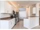 Bright kitchen features stainless steel appliances, white cabinets, granite counters, and a breakfast bar at 1430 Blue Horizon Cir, Bradenton, FL 34208