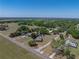 Aerial view of a home situated on expansive land surrounded by lush greenery and scenic countryside at 14721 Scharber Rd, Dade City, FL 33525