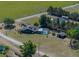 Aerial view of country estate with screened-in pool, detached garage, and mature landscaping at 14721 Scharber Rd, Dade City, FL 33525