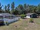 Spacious backyard featuring a screened pool and detached garage at 14721 Scharber Rd, Dade City, FL 33525