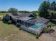 Sprawling backyard with fenced in pool, mature landscaping, and solar panels, offers sustainable living at 14721 Scharber Rd, Dade City, FL 33525