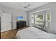 Bedroom featuring a bay window, ceiling fan, and wood-look flooring at 14721 Scharber Rd, Dade City, FL 33525