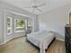 Bright bedroom with a bay window, ceiling fan, and wood-look flooring at 14721 Scharber Rd, Dade City, FL 33525