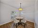 Cozy dining area with chandelier lighting and comfortable seating for four at 14721 Scharber Rd, Dade City, FL 33525