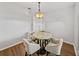 Well-lit dining area featuring a round marble table and four stylish chairs at 14721 Scharber Rd, Dade City, FL 33525