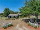 Home exterior featuring lush landscaping, a covered parking area, and a welcoming front yard with a decorated entrance at 14721 Scharber Rd, Dade City, FL 33525