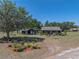 View of home with manicured lawn, and flowerbeds, creating a welcoming curb appeal at 14721 Scharber Rd, Dade City, FL 33525