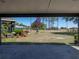 Covered carport with American flag and landscaped front yard at 14721 Scharber Rd, Dade City, FL 33525