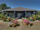 Charming home with a well-maintained front yard, colorful flowers, and decorative garden ornaments at 14721 Scharber Rd, Dade City, FL 33525