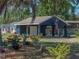 Close-up of a garage and carport showcasing the well-maintained garden and landscaping at 14721 Scharber Rd, Dade City, FL 33525