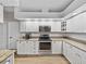 Updated kitchen featuring sleek appliances, granite countertops, and ample cabinet space at 14721 Scharber Rd, Dade City, FL 33525