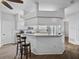 Bright kitchen with white cabinetry, stainless steel appliances, granite countertops, and a breakfast bar at 14721 Scharber Rd, Dade City, FL 33525