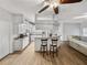 Stylish kitchen featuring an island with seating, granite countertops, stainless steel appliances, and wood floors at 14721 Scharber Rd, Dade City, FL 33525