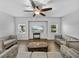 Comfortable living room with wood floors, neutral furniture, a ceiling fan, and a view of the outdoors at 14721 Scharber Rd, Dade City, FL 33525