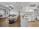 Open-concept living area with wood floors, neutral furniture, and a kitchen with stainless steel appliances at 14721 Scharber Rd, Dade City, FL 33525