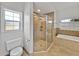 Bright bathroom featuring glass shower, soaking tub, and toilet at 14721 Scharber Rd, Dade City, FL 33525