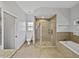 Spacious bathroom featuring glass shower and soaking tub with tile surround at 14721 Scharber Rd, Dade City, FL 33525