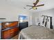 Well-lit main bedroom features exercise equipment, dressers, and wood-look floors at 14721 Scharber Rd, Dade City, FL 33525