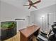 Office space with desk, bookshelf, ceiling fan and aquarium at 14721 Scharber Rd, Dade City, FL 33525