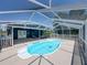 Refreshing screened-in pool and spacious outdoor patio are ideal for relaxation and entertaining at 14721 Scharber Rd, Dade City, FL 33525