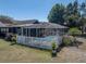 Gated pool area with white picket fence offers privacy and charm in this outdoor retreat at 14721 Scharber Rd, Dade City, FL 33525
