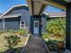 Charming walkway leading to the home's entrance with lush landscaping at 14721 Scharber Rd, Dade City, FL 33525
