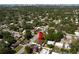 An aerial view of a suburban neighborhood showcases a charming home nestled among lush trees and well-maintained streets at 1644 Scott St, Clearwater, FL 33755