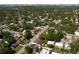 An aerial shot showcases the tranquil neighborhood, lush trees, and clear blue skies at 1644 Scott St, Clearwater, FL 33755