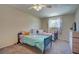This bedroom features two twin beds, ceiling fan, and large window for natural light at 1644 Scott St, Clearwater, FL 33755