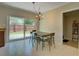 Bright dining area featuring a modern chandelier and sliding glass doors leading to the backyard at 1644 Scott St, Clearwater, FL 33755