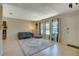 Bright living room featuring neutral walls, a large rug, and bright windows at 1644 Scott St, Clearwater, FL 33755
