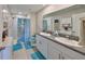 This bathroom features a double sink vanity with granite counters and a standing shower at 16665 Delia St, Wimauma, FL 33598
