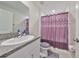 This bathroom features a single sink vanity with granite counters and a standing shower at 16665 Delia St, Wimauma, FL 33598