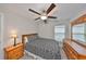 This bedroom features neutral walls, carpeted floors, a ceiling fan, and a closet at 16665 Delia St, Wimauma, FL 33598
