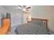 This bedroom features neutral walls, carpeted floors, a ceiling fan, and a closet at 16665 Delia St, Wimauma, FL 33598