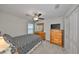 This bedroom features a ceiling fan, and ample furnishings with a bed and dressers at 16665 Delia St, Wimauma, FL 33598