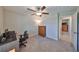 This bedroom features neutral walls, carpeted floors, a ceiling fan, and a closet at 16665 Delia St, Wimauma, FL 33598