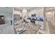 Modern kitchen with granite countertops, stainless steel appliances, and white cabinetry at 16665 Delia St, Wimauma, FL 33598