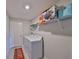Efficient laundry room with washer, dryer, shelving, and storage space for household needs at 16665 Delia St, Wimauma, FL 33598