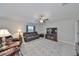 Spacious living room offers a ceiling fan, a comfortable sofa and tile flooring at 16665 Delia St, Wimauma, FL 33598